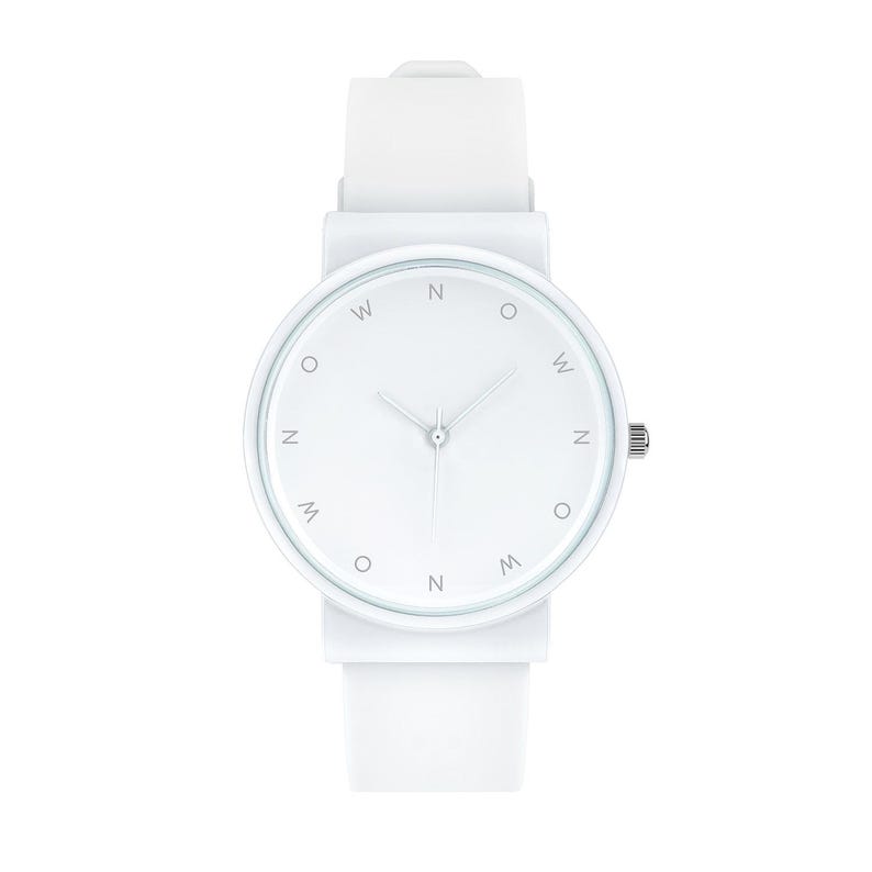 May include: A minimalist white wristwatch with a round face and a white silicone strap. The watch face features the letters "W", "N", and "M" in a circular pattern. The watch has silver hands and a silver crown.