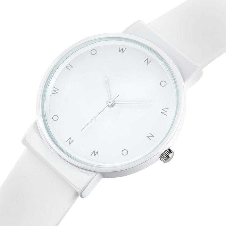 May include: A white wristwatch with a white strap. The watch face is white with silver hands and the letters "W", "N", and "O" marking the hours. The watch has a silver crown.