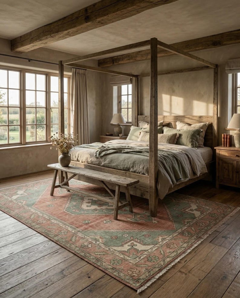 May include: A bedroom with a wooden four-poster bed, a patterned rug, and a wooden bench at the foot of the bed. The rug has a red and green design. The room has large windows and wooden beams on the ceiling.