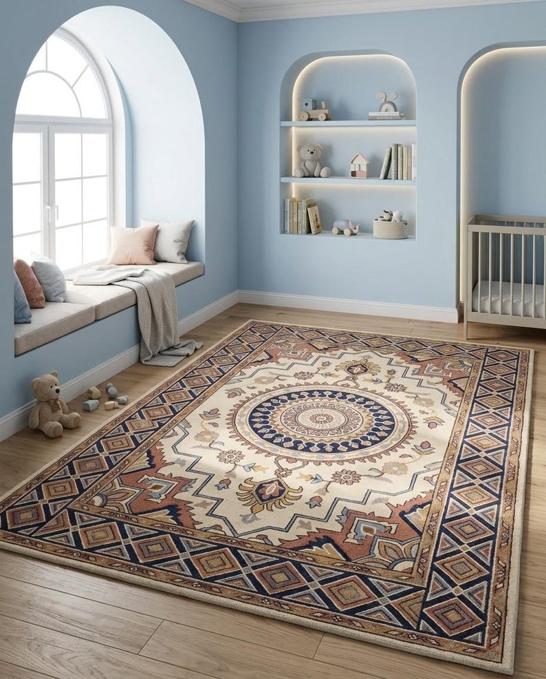 May include: A rectangular rug with a central medallion design in cream, brown, and navy blue. The rug has a geometric border and floral accents, suitable for a living room or bedroom.