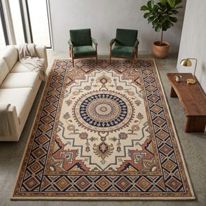 May include: A large rectangular rug with an elaborate geometric and floral pattern. The rug has a cream-coloured background with a central medallion in navy blue and tan. The border includes diamond and geometric patterns in shades of brown, rust, and navy.