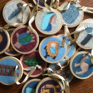 May include: A set of 14 round felt ornaments with various images, including a lamb, a star, a shepherd, and a manger. The ornaments are decorated with colorful felt and embroidery. They are perfect for adding a festive touch to your Christmas decor.