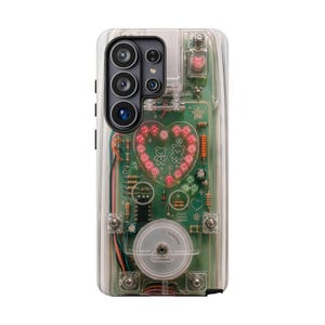 May include: A clear phone case featuring an exposed green circuit board design with a heart-shaped arrangement of pink LED lights, two small bear illustrations, various electronic components, and a circular white dial on the lower section.