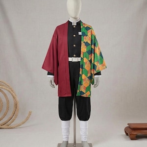 May include: A costume featuring a black top and pants, a burgundy overcoat, and a patterned green, yellow, and orange haori. The outfit includes a white belt, white socks, and gold buttons. The costume is displayed on a mannequin.