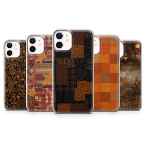 May include: Five clear phone cases featuring distinct designs: a brown leopard print, a red and tan plaid with stars, a black and brown geometric patchwork, an orange and brown checkered pattern, and a dark forest scene with gold accents.