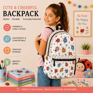 May include: A white backpack featuring a repeating pattern of colorful ladybugs and small flowers. The bag includes a front zippered pocket, black straps, and black trim. The design is printed on a durable fabric with a structured shape and side pockets.