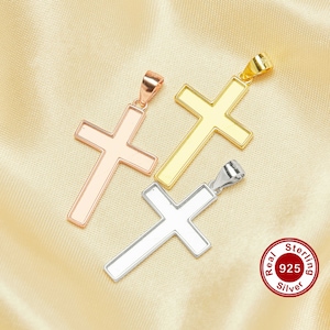 May include: Three cross pendants in different metal finishes: rose gold, gold, and silver. The silver pendant has a "Real Sterling 925 Silver" stamp.