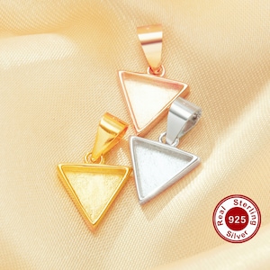 May include: Close-up of four triangle-shaped pendant trays in gold, rose gold, and silver tones. The pendants have a loop at the top for a chain. The image includes a Real 925 Sterling Silver seal.