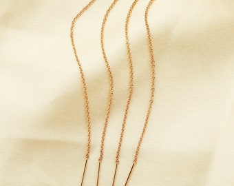 May include: Four gold chain extenders with a small gold bar at the end of each chain.