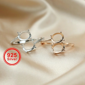 May include: Two oval ring settings, one in silver and one in gold, with a 925 silver stamp on the silver ring.