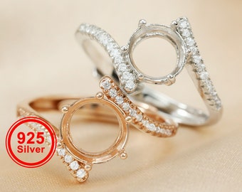 May include: Two silver rings with clear stones and one rose gold ring with clear stones. The rings are all set with a round bezel setting. The rings are 925 silver.
