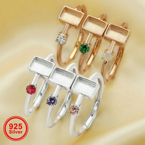 May include: Four silver rings with rectangular bezels and colorful gemstones. The rings are stacked on top of each other. The bezels are empty and ready to be filled with resin or other materials. 925 Silver.