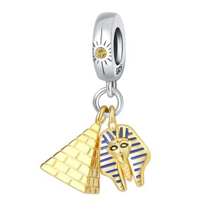 May include: Silver charm with a gold pyramid and a gold pharaoh head with blue stripes. The charm has a small yellow gemstone.