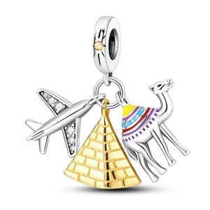 May include: Silver charm with a gold pyramid, a silver airplane with clear crystals, and a silver camel with colorful decorations.