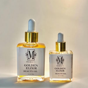 May include: Two glass bottles of beauty oil with gold accents and white labels. The labels read "HAWAI'I GOLDEN ELIXIR BEAUTY OIL". The bottles have white droppers and are filled with a golden liquid. One bottle is 1 fl oz, the other is 0.5 fl oz.