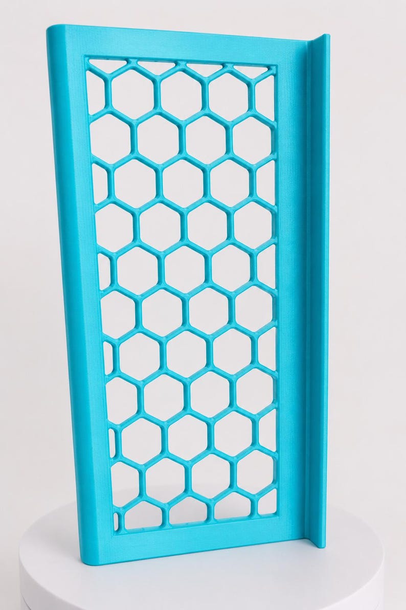 May include: A bright cyan rectangular panel featuring a repeating hexagonal honeycomb grid pattern. The structure is framed by solid vertical borders on the left and right sides, creating a rigid, open-work design with a matte finish throughout.