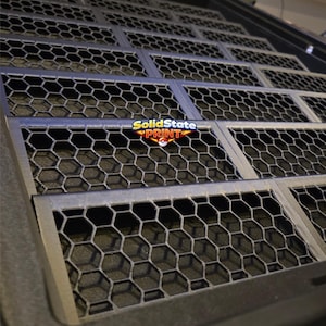 May include: A black rectangular tray featuring a repeating hexagonal grid pattern across its surface. The tray has a raised border and includes a central logo graphic that reads SolidState PRINT with a small red and white circular icon.