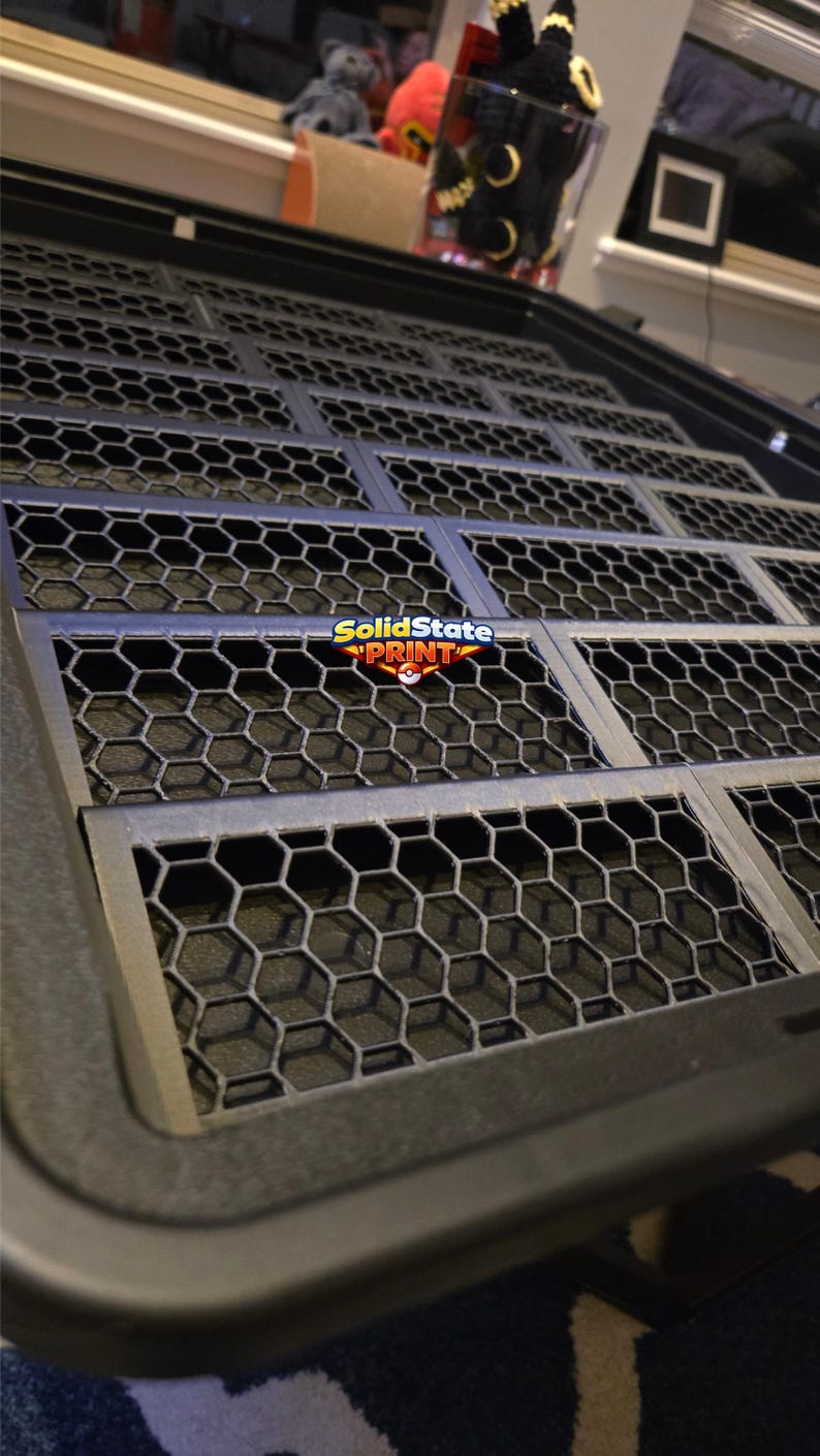 May include: A black rectangular tray featuring a repeating hexagonal grid pattern across its surface. The tray has a raised border and includes a central logo graphic that reads SolidState PRINT with a small red and white circular icon.