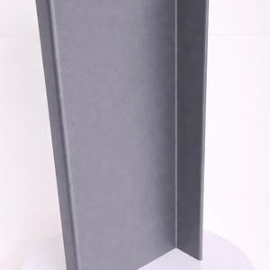 May include: A tall, L-shaped display board with a smooth, matte gray finish. The structure consists of two rectangular panels joined at a right angle, creating a vertical corner profile that stands upright on a circular white base.