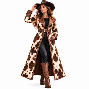 May include: A long, floor-length coat featuring a cream and brown floral pattern, accented with solid brown leather-like lapels, cuffs, pocket flaps, and a matching belt with a gold-tone buckle. The coat is worn over a black top and black pants.