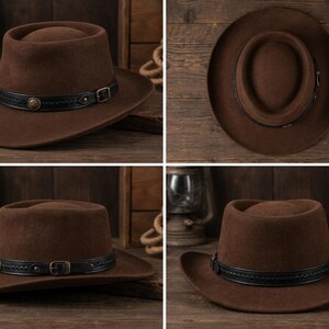 May include: A brown felt hat featuring a flat crown and a wide brim. The hat is accented with a black leather band that includes a braided texture, a metallic buckle, and a circular decorative stud on the side, shown from multiple angles.