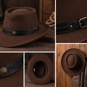 May include: A brown felt hat with a flat crown and a wide brim. The hat features a black leather band decorated with a braided pattern, a metallic buckle, and a circular concho ornament. The interior of the hat shows a black sweatband.