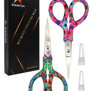 May include: Two pairs of stainless steel scissors with colourful patterned handles, one featuring a red, green, and blue design and the other a pink and blue floral pattern. Includes a black box labelled RISORTON BEST QUALITY WITH EXPERT BLEND.