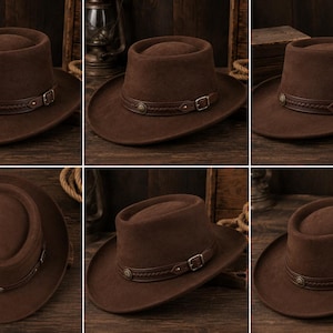 May include: A dark brown felt hat with a wide brim and a rounded crown. The hat features a decorative dark brown leather band around the base, accented with a braided texture, a small metal buckle, and a circular metal stud detail on the side.