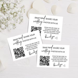 May include: Three white rectangular cards with black text and a QR code. The text reads: SNAP and SHARE YOUR wedding PHOTOS WITH US. SCAN THE QR CODE TO UPLOAD & SHARE THE PHOTOS YOU HAVE TAKEN OF OUR WEDDING DAY. The cards also include the word thank you.
