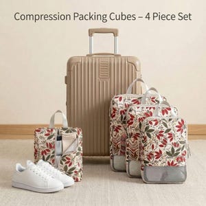 May include: A tan rolling suitcase stands next to a set of compression packing cubes with a floral pattern of red and green leaves. The text "Compression Packing Cubes - 4 Piece Set" is at the top. A pair of white sneakers is in the foreground.