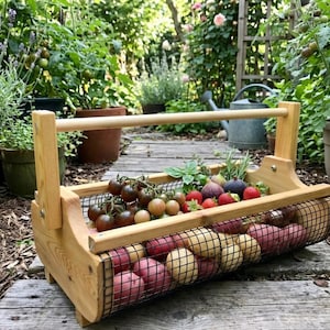 May include: A white ceramic mug with a black handle and the text "But First, Coffee" in a black, bold font. The mug is on a white surface.