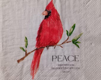 May include: A white paper napkin featuring a watercolor illustration of a bright red cardinal bird perched on a brown branch with green leaves. The text reads PEACE, I leave with you, my peace I give unto you, John 14:27.