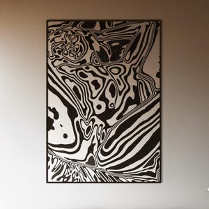 May include: A bedroom with a modern aesthetic. A large black and white abstract art piece hangs above a bed with a dark gray comforter. The room has large windows and a wooden floor.