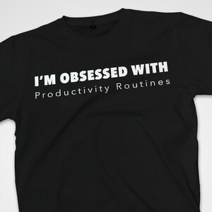 May include: A white ceramic mug with a black handle and the text "But First, Coffee" in a bold, black font. The mug is filled with a dark liquid, likely coffee, and sits on a light-colored surface.