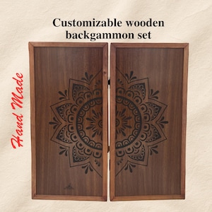 May include: A customizable wooden backgammon set with a dark wood finish. Each board has a black mandala design. The words "Hand Made" are written in red script.