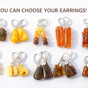 May include: A selection of amber earrings with silver hooks. The earrings display a variety of shapes and colours, from dark brown to golden yellow. The text "YOU CAN CHOOSE YOUR EARRINGS!" is visible at the top.