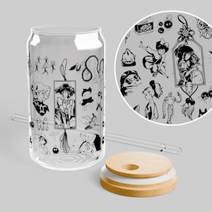 May include: A clear glass can-shaped tumbler featuring a black line art pattern of various animated characters and motifs. The set includes a matching clear glass straw and a round, light-colored wooden lid with a circular opening for the straw.