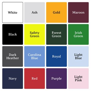 May include: A grid of sixteen color swatches, each with a color name in white text. Colors include white, ash, gold, maroon, black, safety green, forest green, Irish green, dark heather, Carolina blue, royal, light blue, navy, red, purple, and light pink.