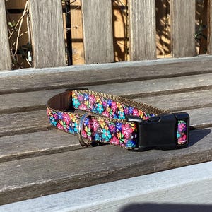 May include: A white ceramic mug with a black handle and the text "But First, Coffee" in a black, bold font. The mug is sitting on a wooden surface.