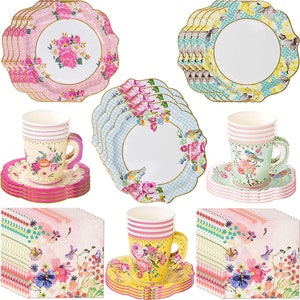 May include: A set of floral themed paper party supplies, including plates, cups, and napkins. The plates have a scalloped edge and feature a pink, blue, and green floral pattern. The cups are white with a pink and green floral pattern. The napkins are pink with a floral pattern.
