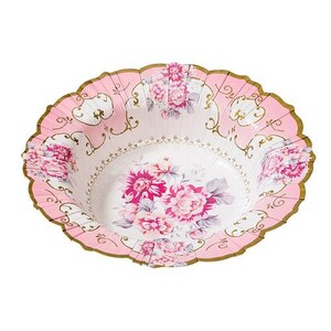 May include: A pink and white floral paper bowl with a scalloped edge and gold trim. The bowl features a floral design with pink and white flowers. The bowl is designed for serving food at a party or event.