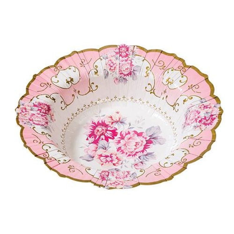 May include: A pink and white floral paper bowl with a scalloped edge and gold trim. The bowl features a floral design with pink and white flowers. The bowl is designed for serving food at a party or event.