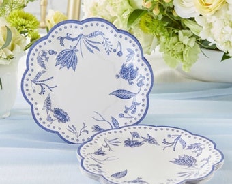 May include: Blue and white floral patterned paper plates with scalloped edges. The plates are stacked on a light blue surface.