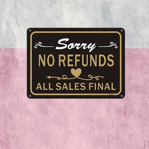 May include: Black and gold sign with the text "Sorry - No Refunds - All Sales Final" with a heart symbol.