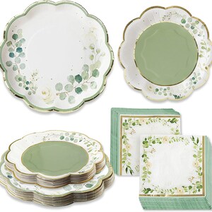 May include: Set of green and white floral paper plates and napkins. The plates have a scalloped edge and a gold rim. The napkins have a green border and a white center with a floral design.
