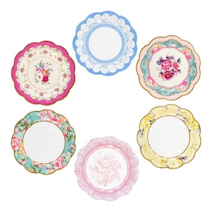 May include: Six decorative paper plates with scalloped edges and floral designs. The plates are in shades of pink, blue, yellow, and green.