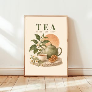 May include: A vertical wall art print on a cream background featuring the text TEA STEEP SIP STAY in dark green. The illustration depicts a green teapot, a small white teacup, chamomile flowers, and orange slices on a stone-like base.