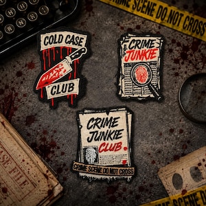 May include: Three embroidered patches featuring true crime themes. One patch shows a bloody knife with the text COLD CASE CLUB. Another depicts a magnifying glass over a fingerprint on a newspaper with CRIME JUNKIE. The third shows CRIME JUNKIE CLUB.