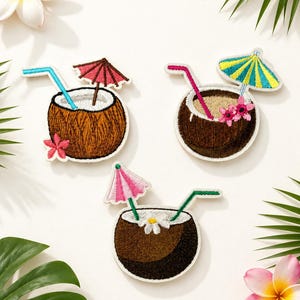 May include: Three embroidered patches shaped like coconut drinks. Each patch features a brown coconut shell, a colorful cocktail umbrella, a drinking straw, and floral accents in shades of pink, white, yellow, and blue with green details.