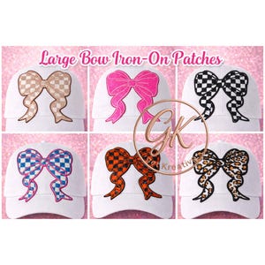 May include: Six white baseball caps with large bow iron-on patches. The bows feature various patterns, including checkered, leopard print, and solid colors like pink and orange. The text "Large Bow Iron-On Patches" is displayed above.